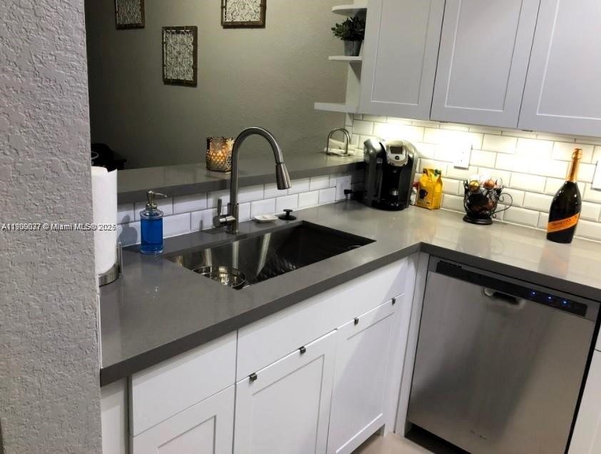 4913 Southwest 141st Avenue, Unit 2 Miramar, FL 33027 - Photo 10 of 12 a kitchen with a sink cabinets and appliances