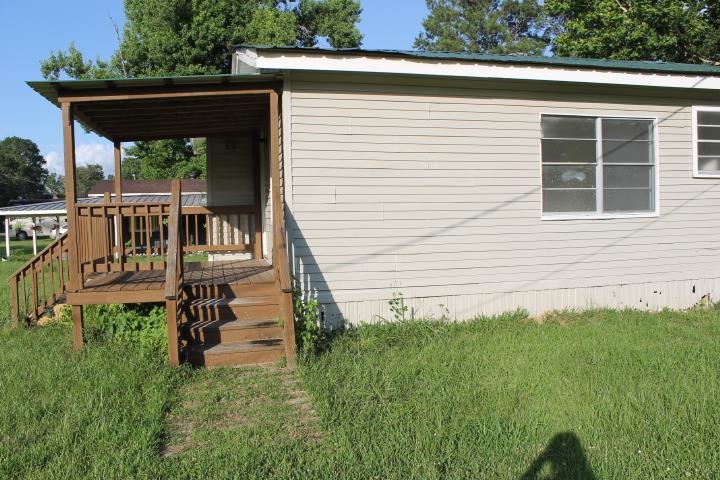 875 Woodrow Street Silsbee, TX 77656 - Photo 4 of 30 a view of a house with a small yard and wooden fence