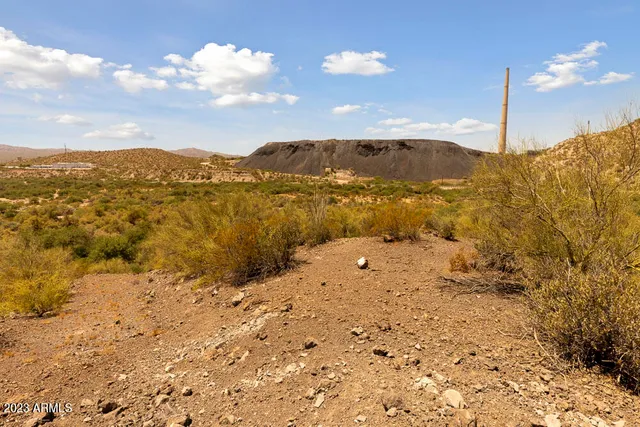 a view of a mountain with wooden fence