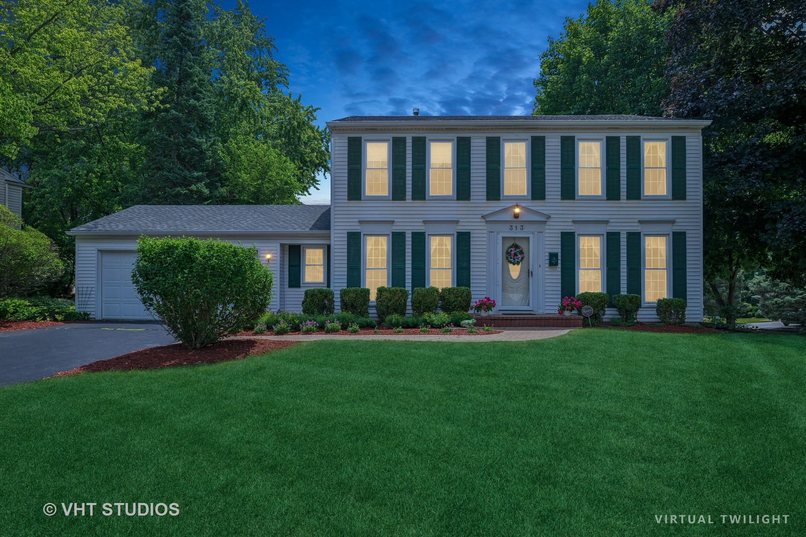 313 Ambleside Drive Roselle, IL 60172 - Photo 31 of 46 a front view of a house with garden and porch