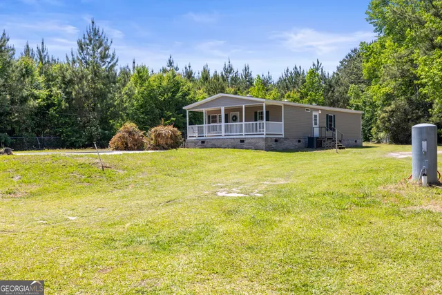 a view of a swimming pool with a yard in front of it