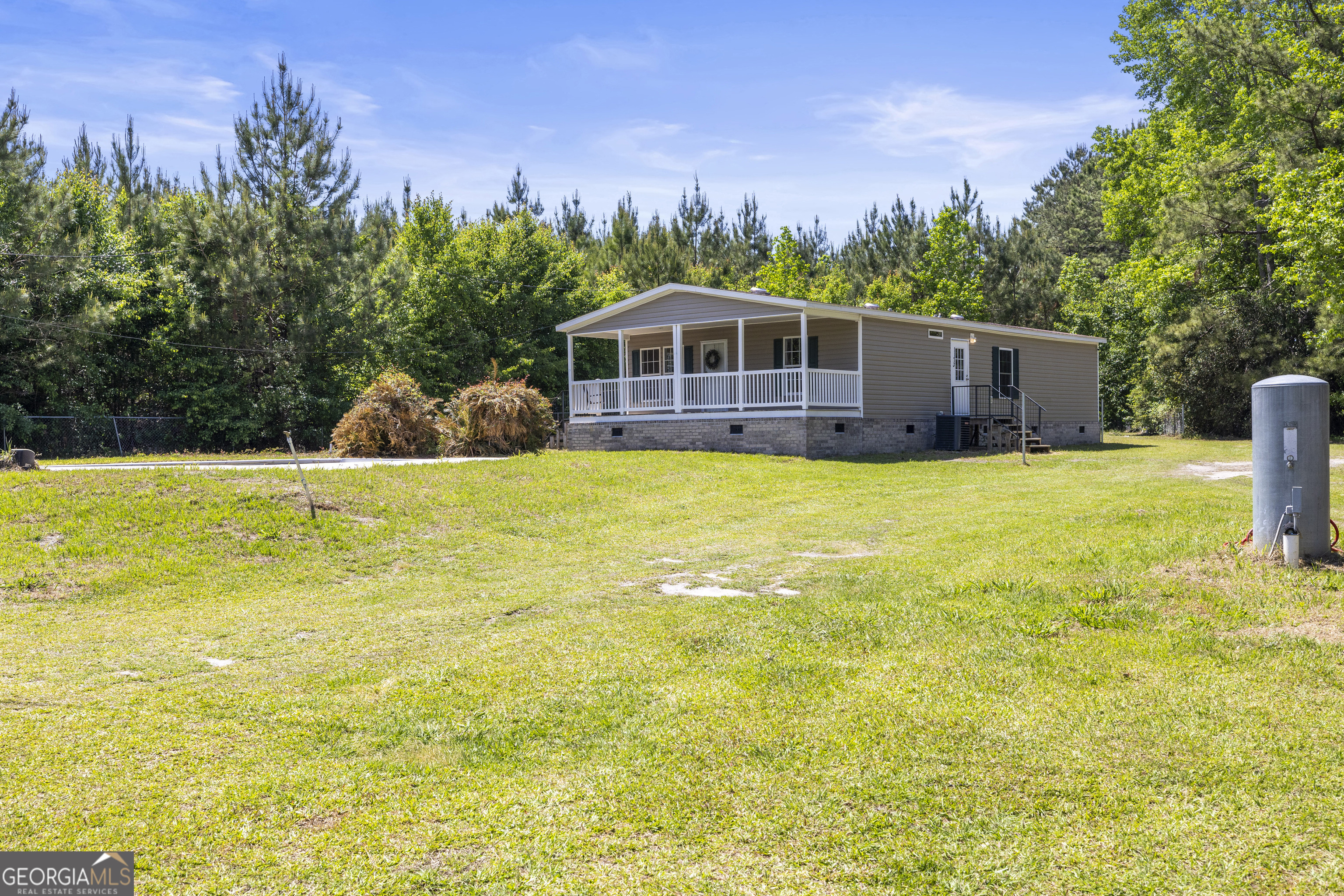a view of a swimming pool with a yard in front of it