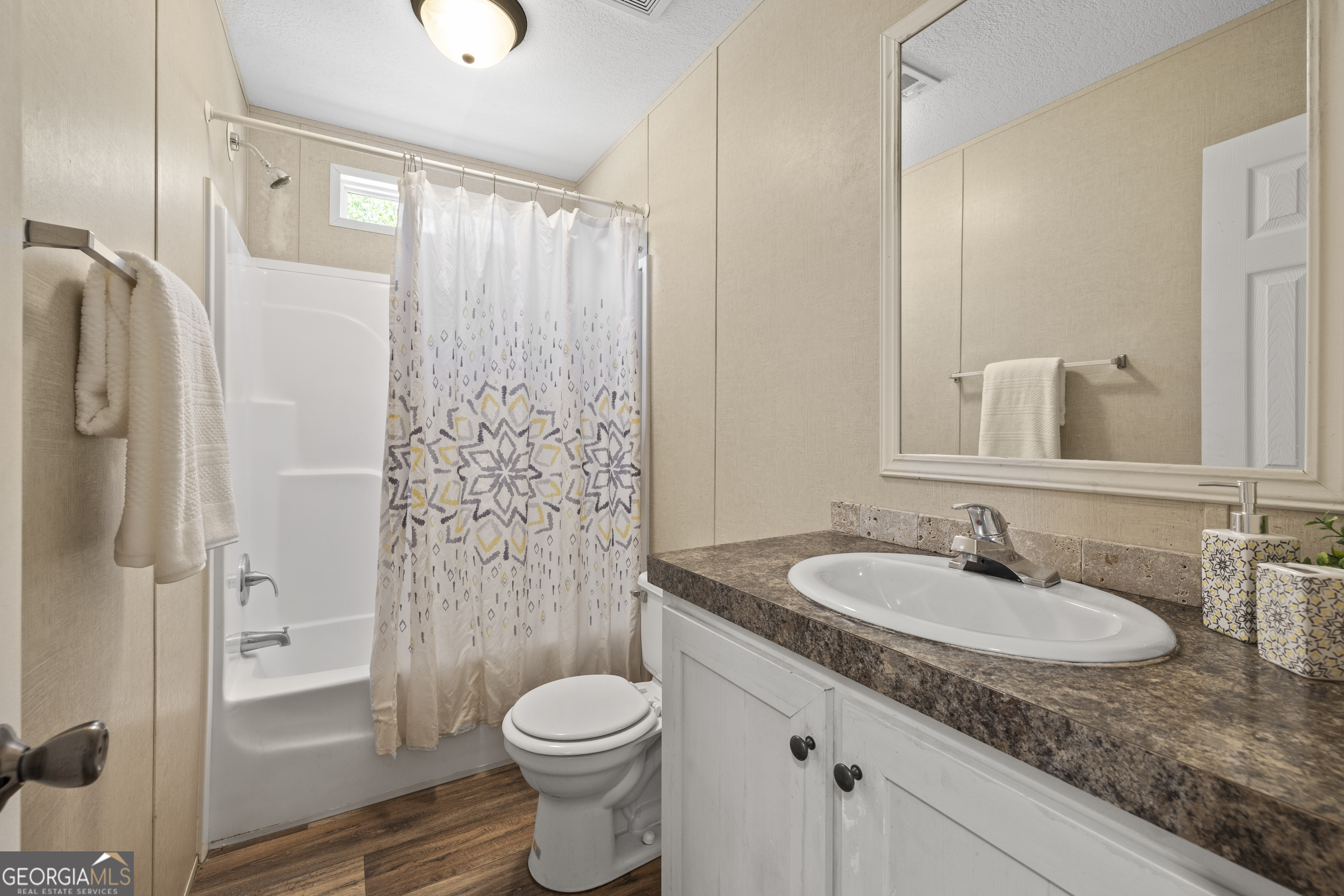 1173 Highway 21 Springfield, GA 31329 - Photo 15 of 18 a bathroom with a granite countertop sink toilet and shower