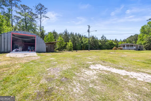 a swimming pool with outdoor seating and yard