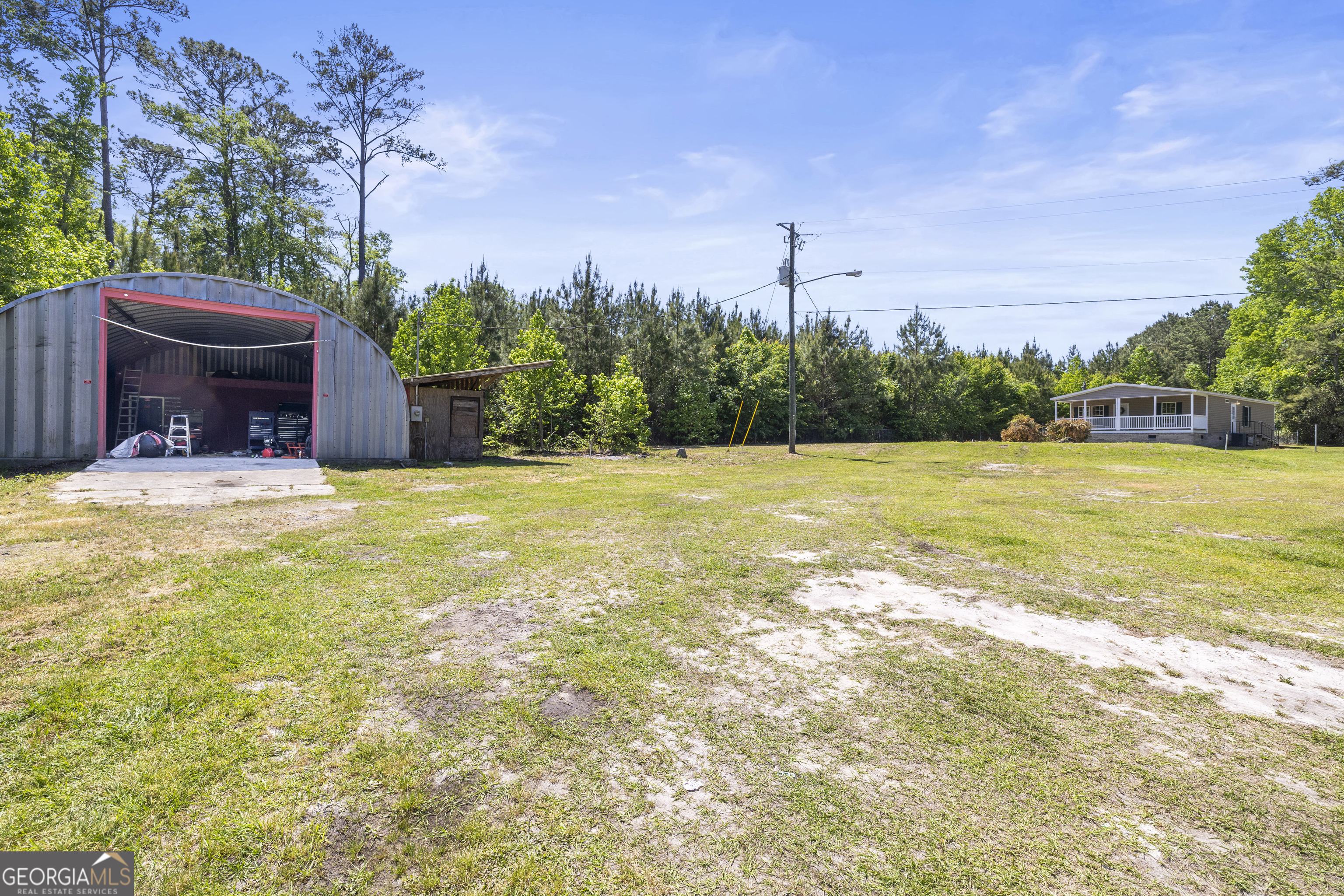 1173 Highway 21 Springfield, GA 31329 - Photo 17 of 18 a swimming pool with outdoor seating and yard