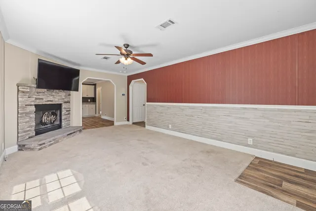 a view of an empty room with a fireplace