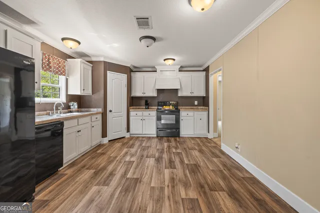 a kitchen with granite countertop white cabinets and white appliances