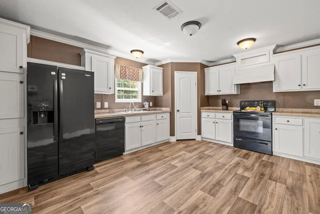 a kitchen with stainless steel appliances granite countertop a refrigerator sink and cabinets