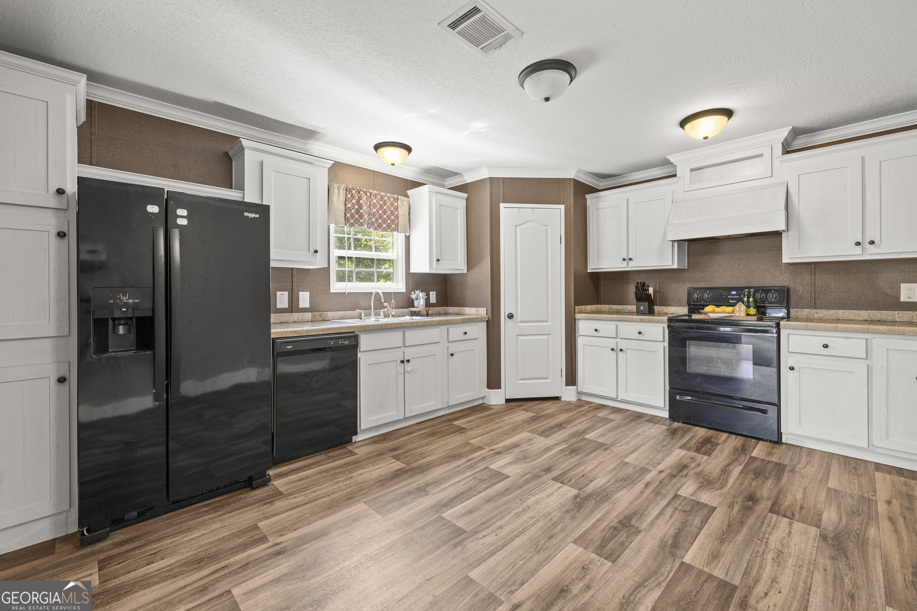 1173 Highway 21 Springfield, GA 31329 - Photo 7 of 18 a kitchen with stainless steel appliances granite countertop a refrigerator sink and cabinets
