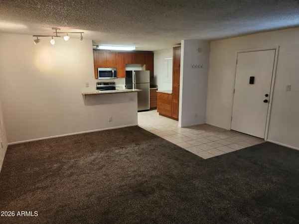 a kitchen with granite countertop a refrigerator and a sink