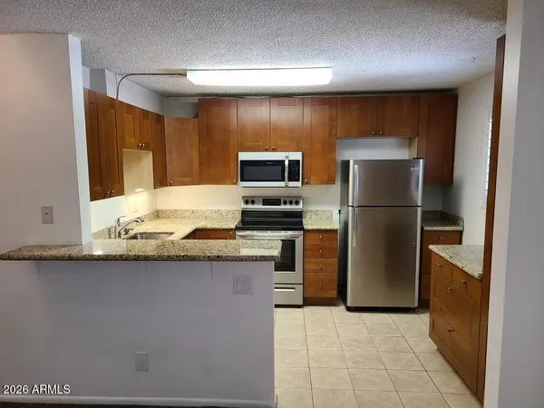 a kitchen with a refrigerator and a sink