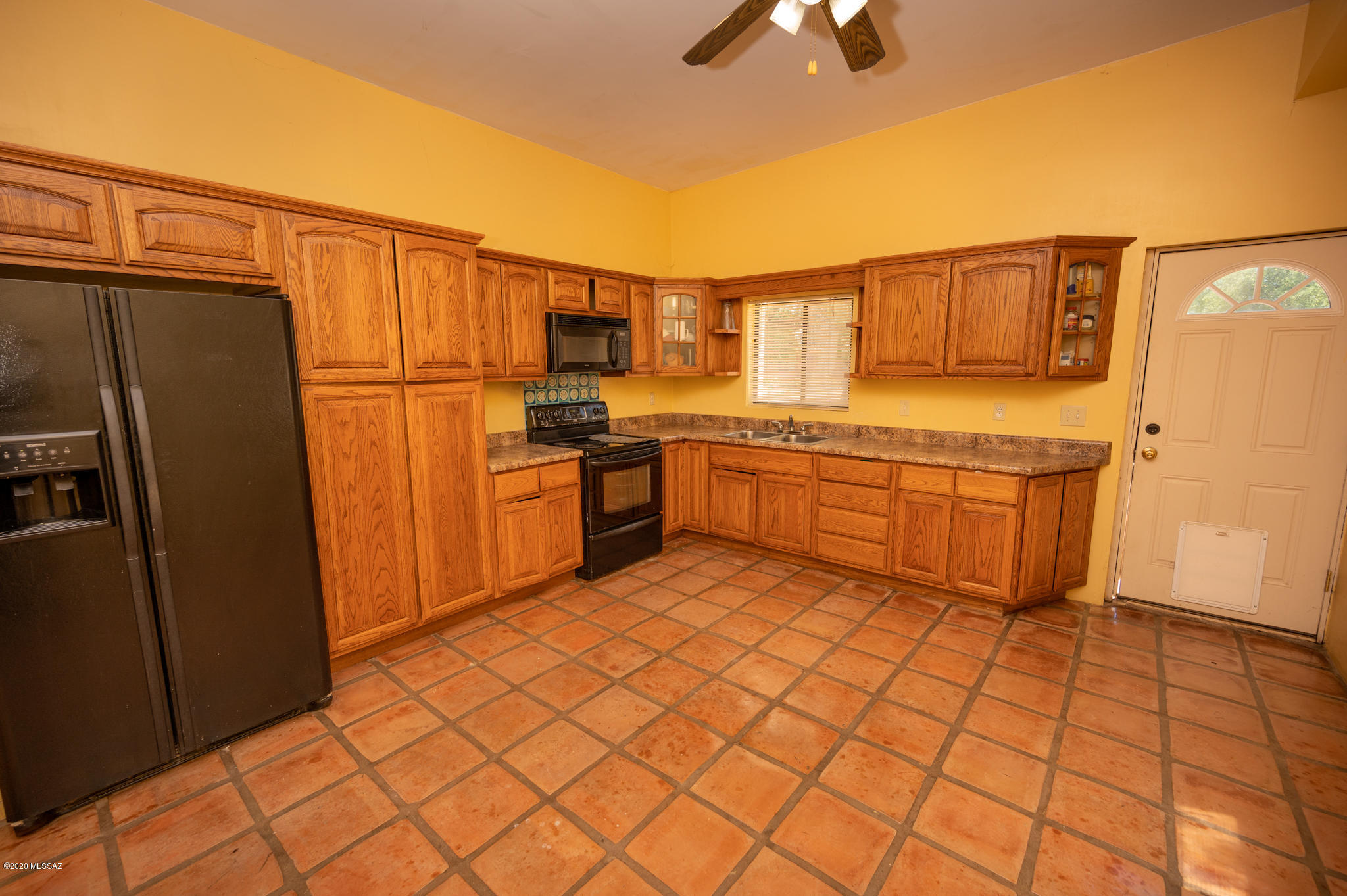 964 Calle Robalo Rio Rico, AZ 85648 - Photo 18 of 35 a kitchen with stainless steel appliances granite countertop a refrigerator and a stove top oven