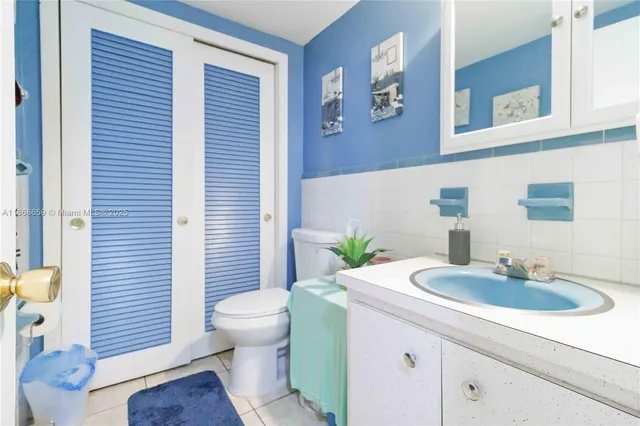 a bathroom with a sink a toilet and mirror