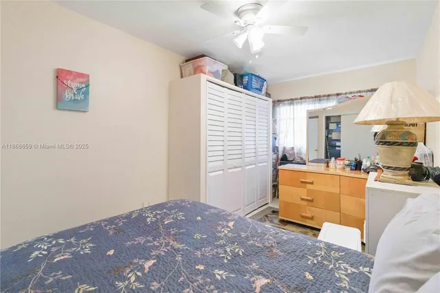 a bed room with a bed mirror and a window