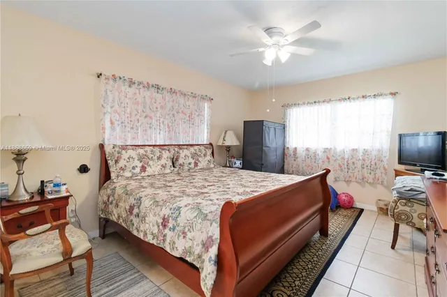 a bedroom with bed and a chandelier