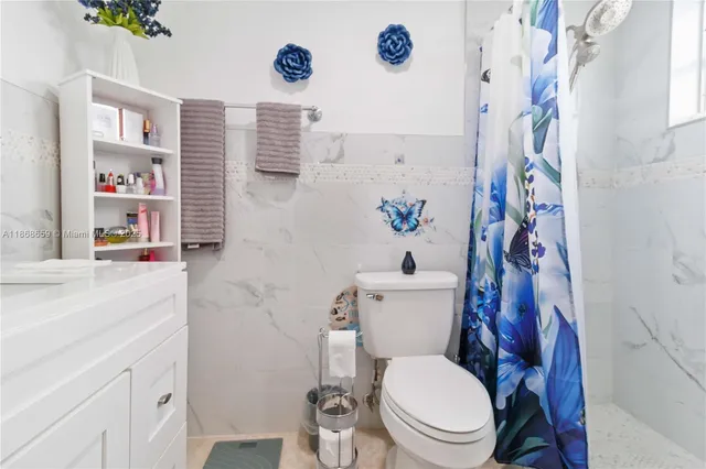 a white toilet sitting next to a bathroom sink