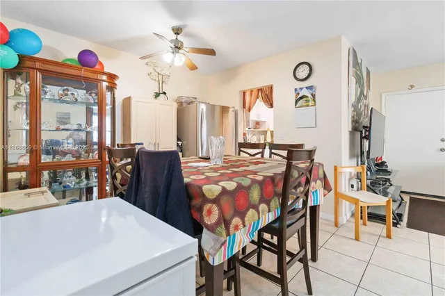 a dining room with furniture and a large window