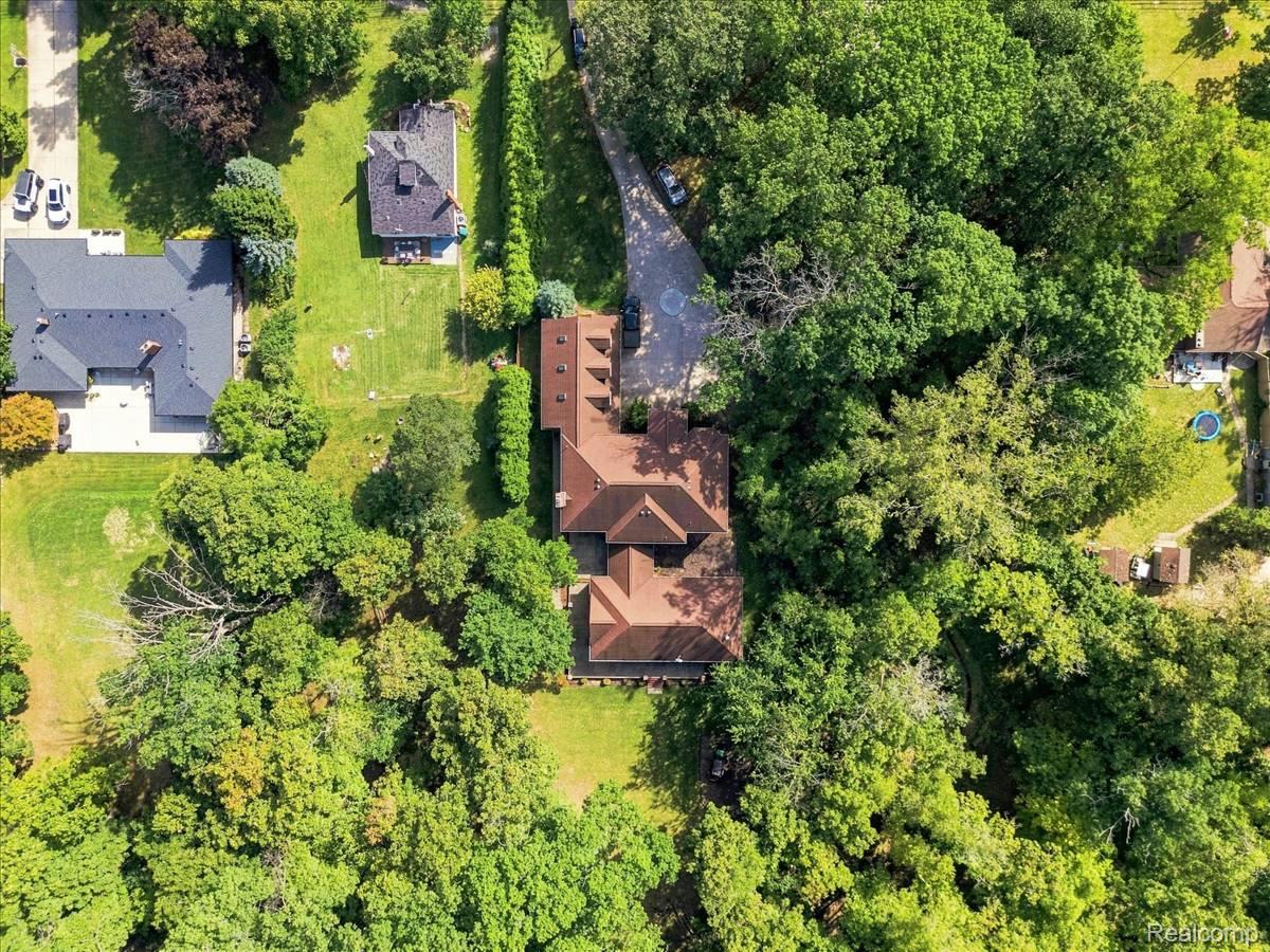 8610 Ferry Road Grosse Ile, MI 48138 - Photo 49 of 55 Expansive property featuring mature trees and a substantial residence with a multi-gabled roofline