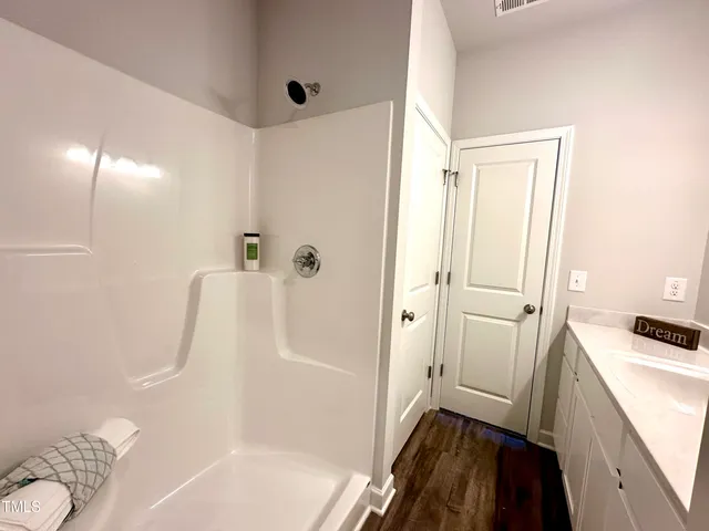 a bathroom with a tub and a shower