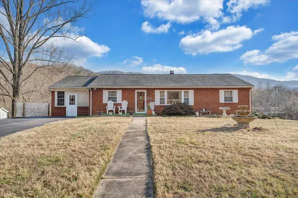 a front view of a house with yard and garage