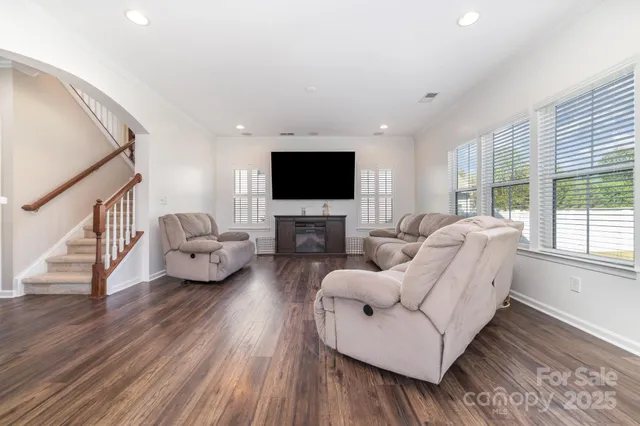 a living room with furniture fireplace and a flat screen tv