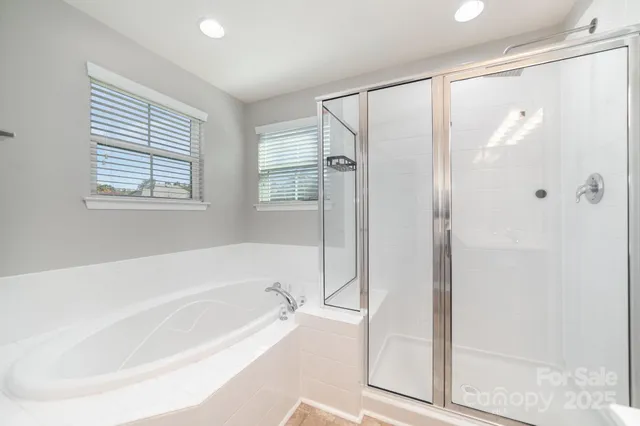 a bathroom with a bathtub and a shower