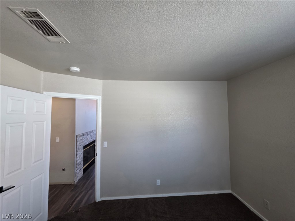 2275 Ramsgate Drive Henderson, NV 89074 - Photo 77 of 84 A spacious room awaits, offering a clear view into an adjoining area with a fireplace.
