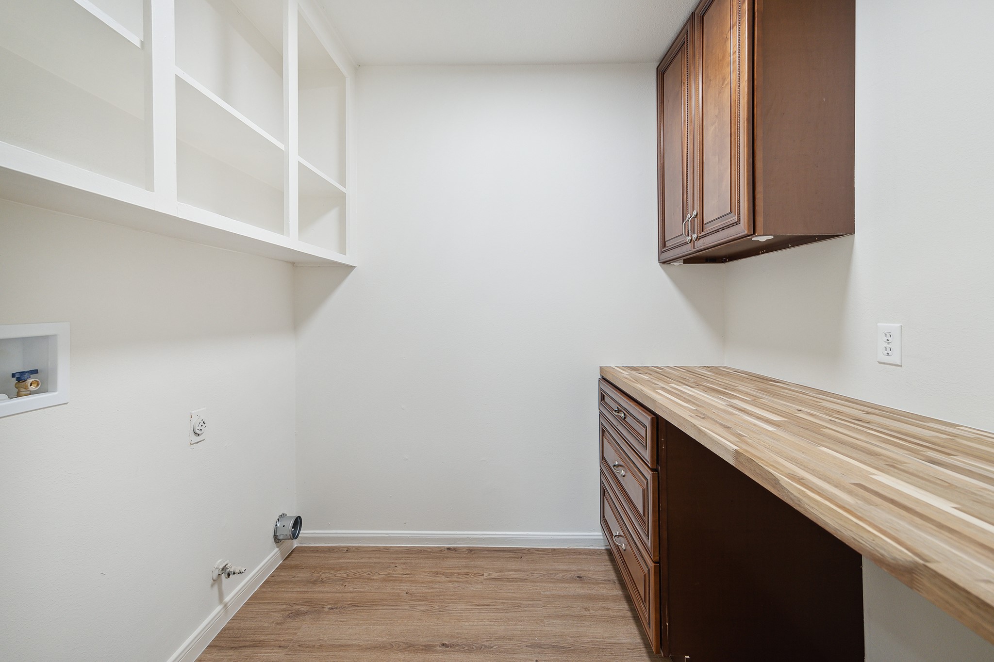 9719 Springmont Drive Houston, TX 77080 - Photo 29 of 32 Even the laundry room has been upgraded with custom cabinetry and a beautiful butcher black work surface perfect for folding and sorting laundry! Gas and electric connections for your dryer!