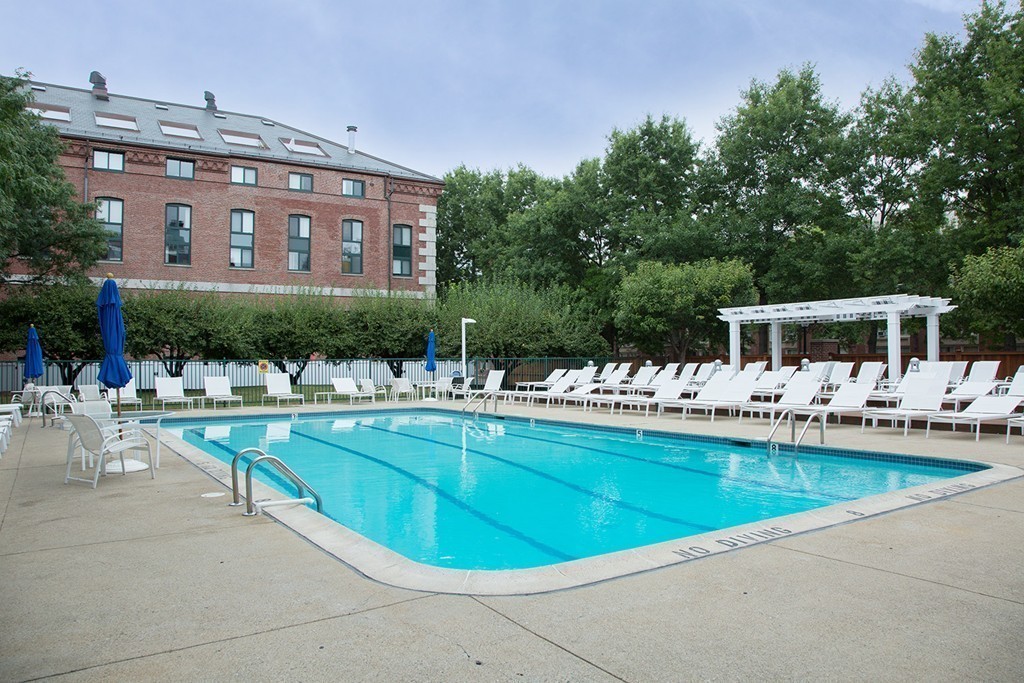 42 8th Street, Unit 4106 Boston, MA 02129 - Photo 12 of 17 a view of swimming pool with outdoor seating and a yard