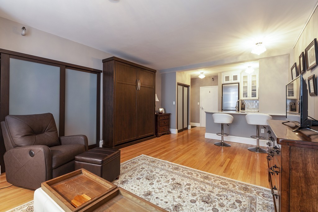 42 8th Street, Unit 4106 Boston, MA 02129 - Photo 3 of 17 a living room with furniture and a flat screen tv