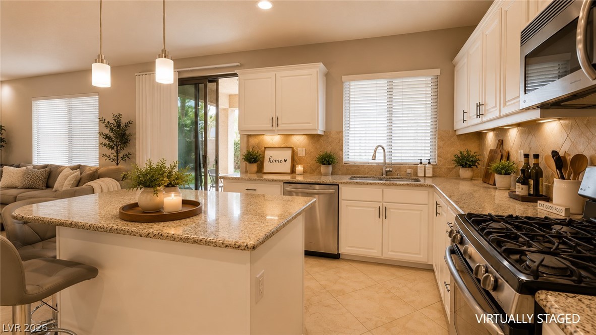 87 Tall Ruff Drive Las Vegas, NV 89148 - Photo 50 of 71 A well-appointed culinary space featuring granite counters and stainless steel appliances.