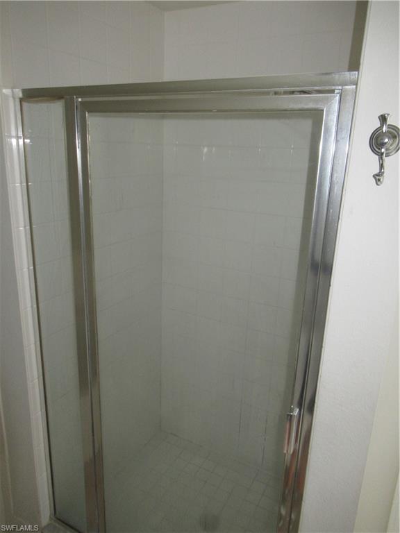 7965 Preserve Circle, Unit 732 Naples, FL 34119 - Photo 16 of 28 a bathroom with a glass shower door