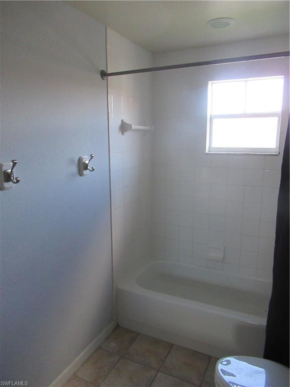 7965 Preserve Circle, Unit 732 Naples, FL 34119 - Photo 18 of 28 a bathroom with a bathtub and window