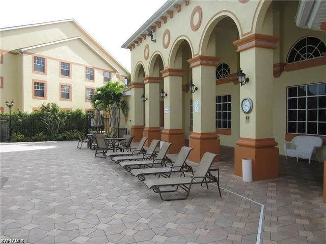 a view of a chair and tables in the balcony
