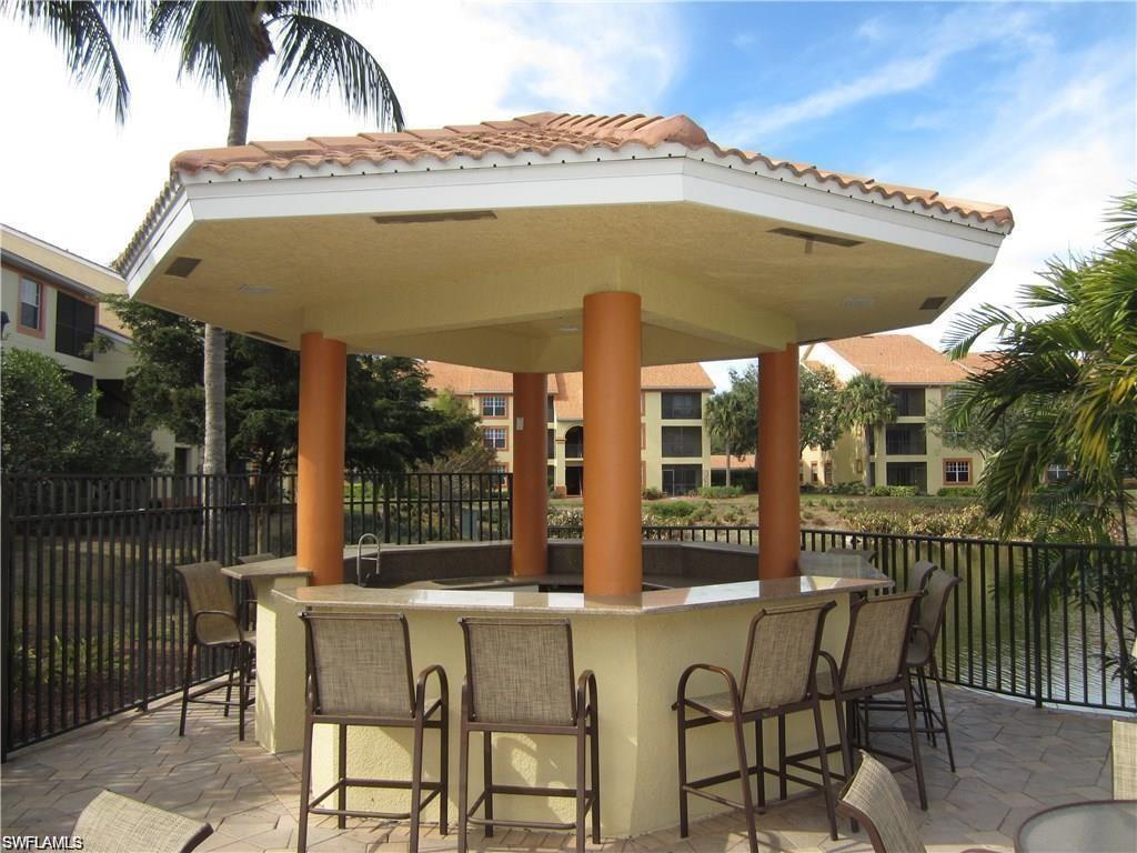 7965 Preserve Circle, Unit 732 Naples, FL 34119 - Photo 27 of 28 a view of a chair and tables in the balcony