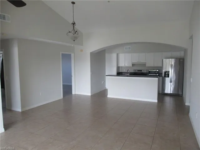 a view of a kitchen with a sink and a refrigerator