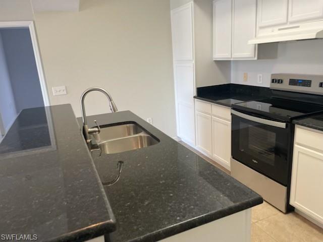 7965 Preserve Circle, Unit 732 Naples, FL 34119 - Photo 5 of 28 a kitchen with granite countertop a sink a stove and cabinets