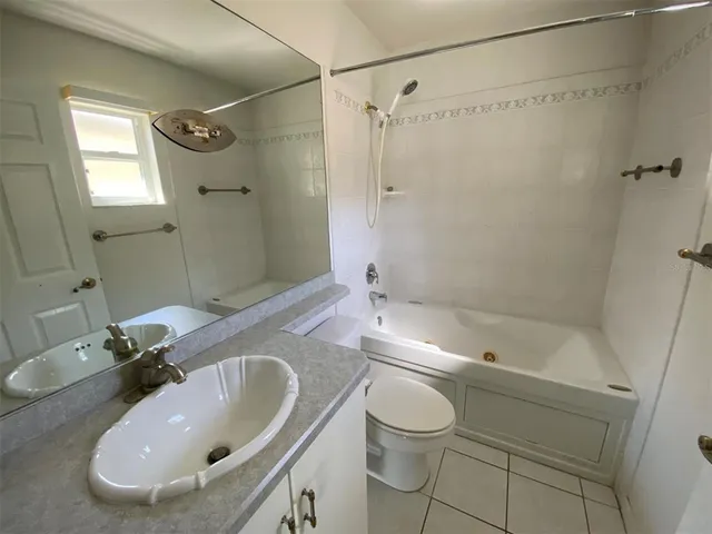 a view of a swimming pool with a yard and wooden fence