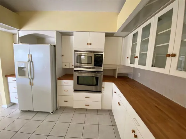 a kitchen with stainless steel appliances a refrigerator and a stove top oven