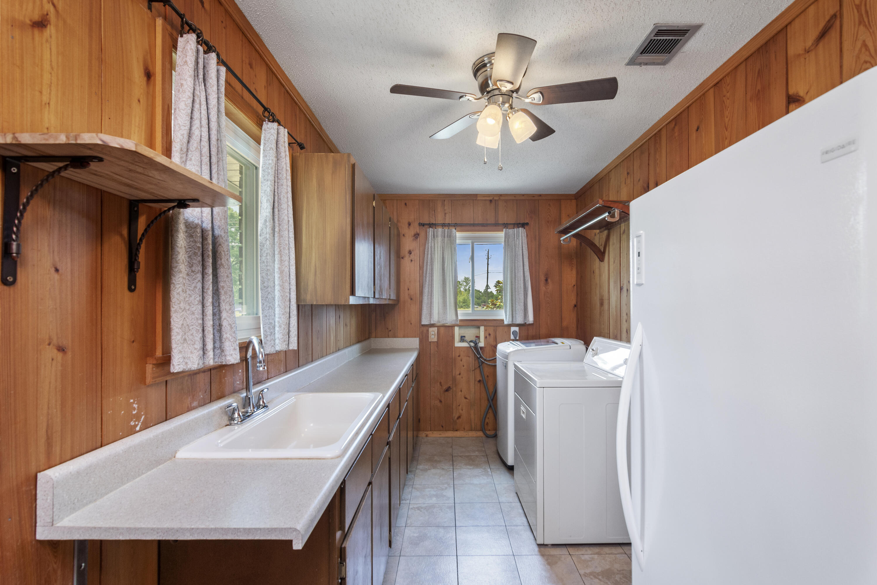 5489 Highway 4 Baker, FL 32531 - Photo 13 of 65 a bathroom with a sink a large mirror and a bathtub