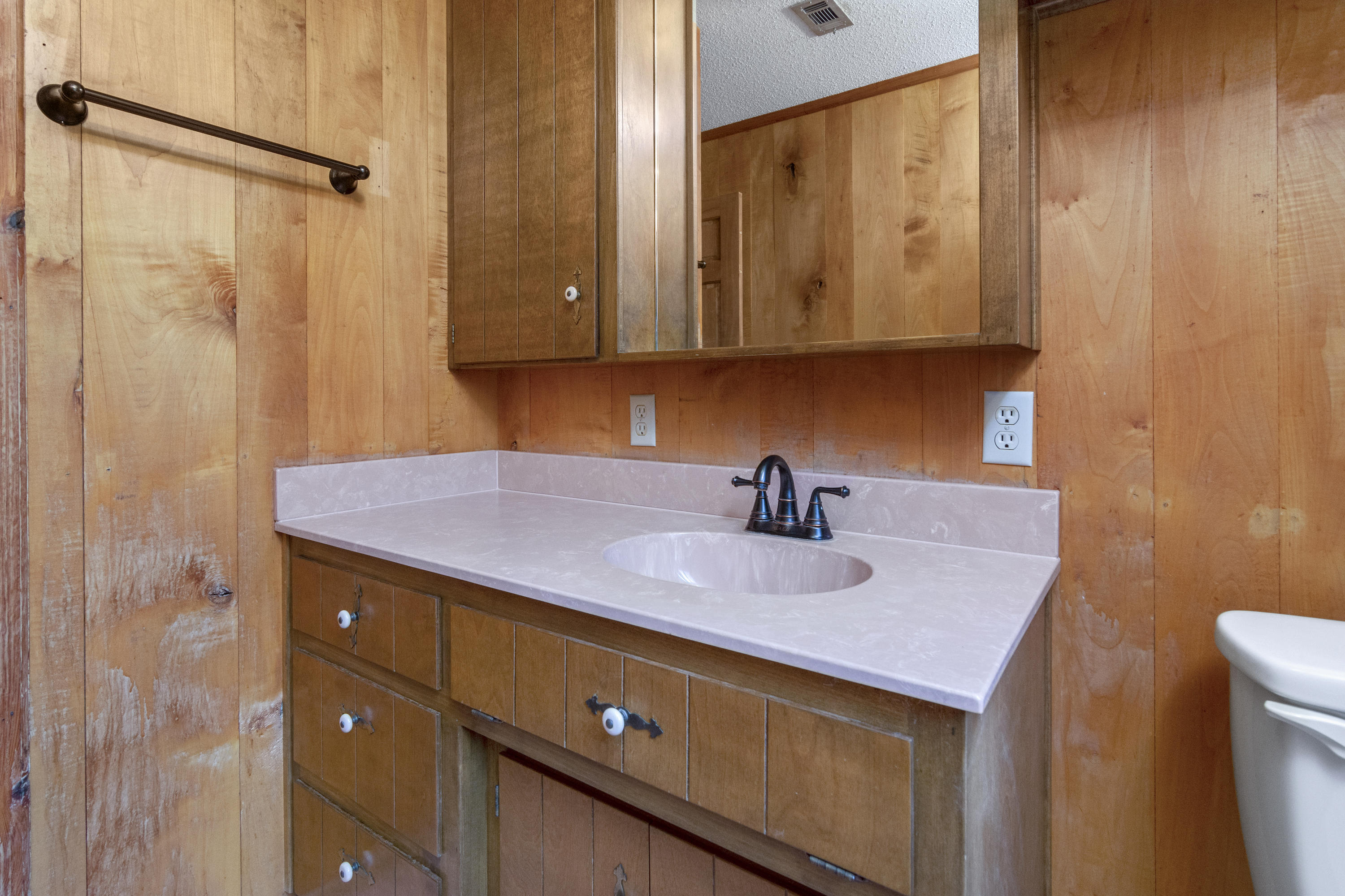 5489 Highway 4 Baker, FL 32531 - Photo 25 of 65 a bathroom with a granite countertop sink and a mirror
