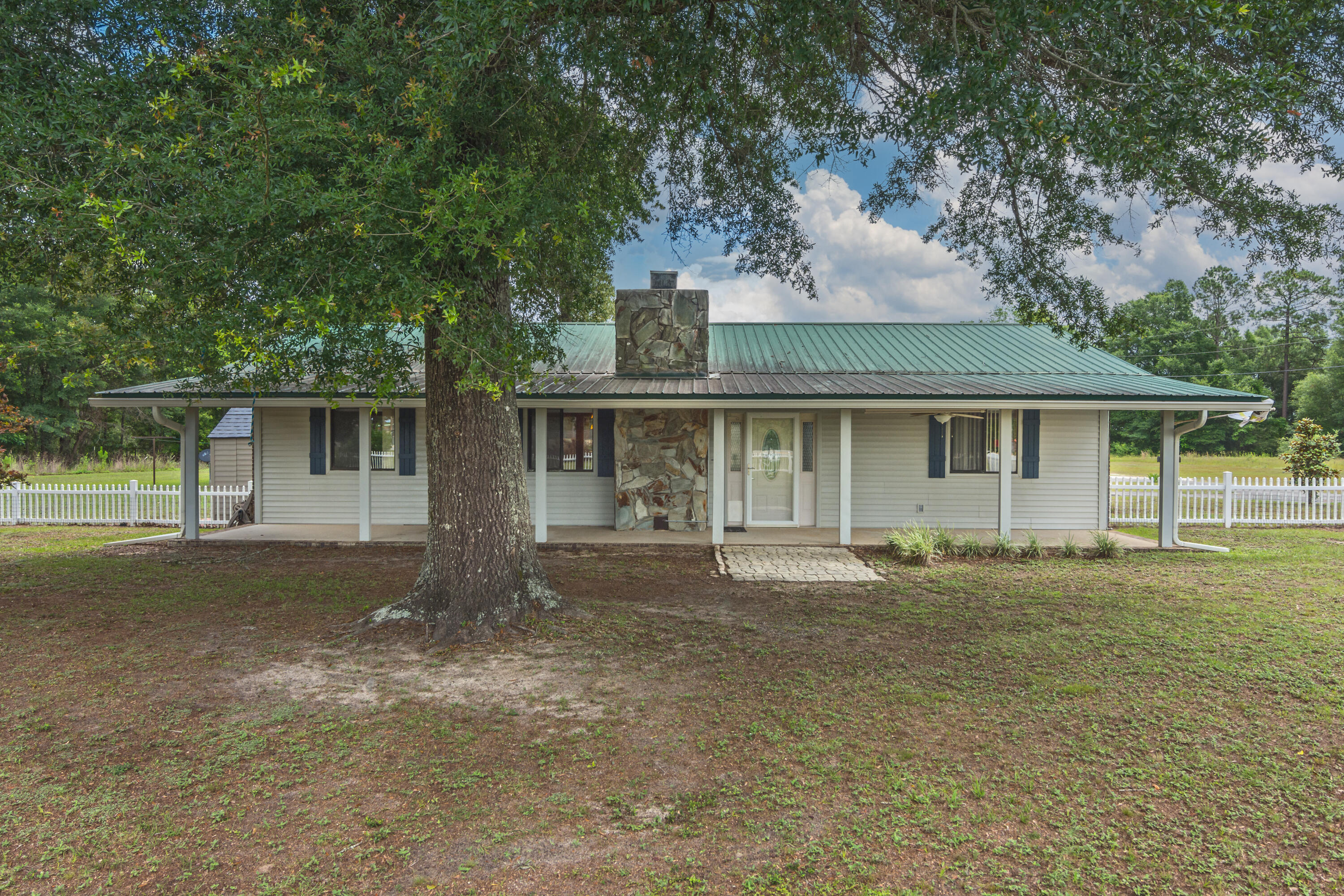 5489 Highway 4 Baker, FL 32531 - Photo 4 of 65 front view of a house with a garden