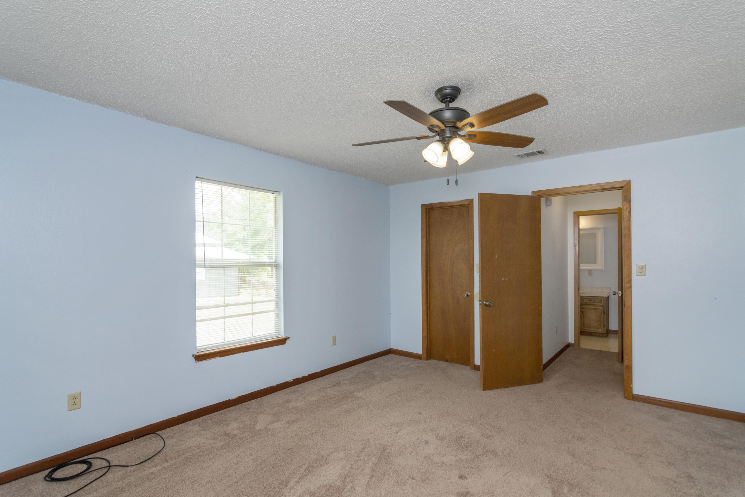 5489 Highway 4 Baker, FL 32531 - Photo 46 of 65 an empty room with closet and ceiling fan