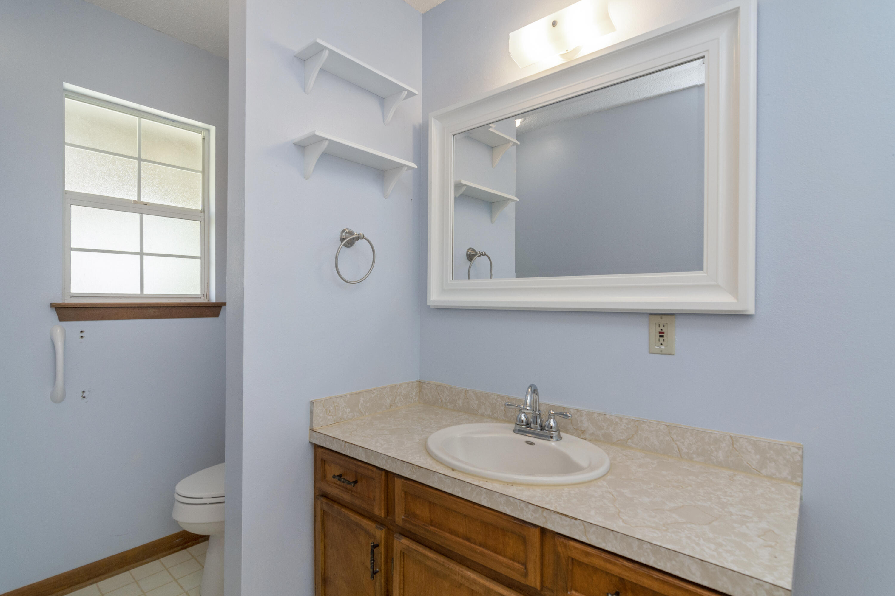 5489 Highway 4 Baker, FL 32531 - Photo 47 of 65 a bathroom with a granite countertop sink toilet and mirror