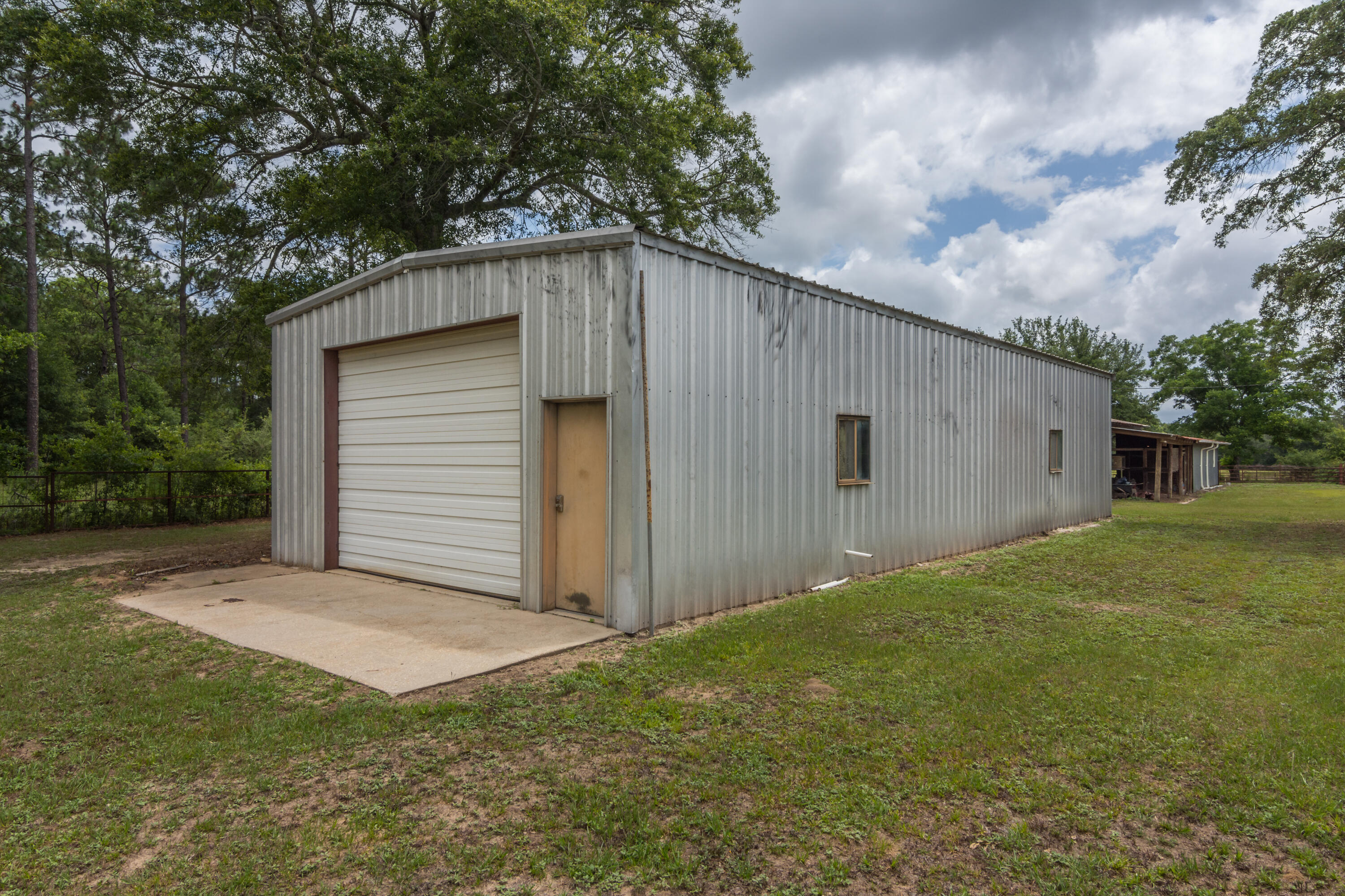 5489 Highway 4 Baker, FL 32531 - Photo 50 of 65 a backyard of a house with plants and a yard