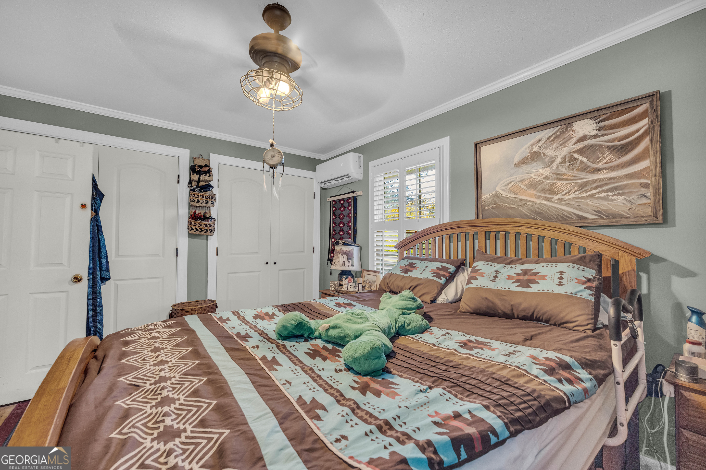 62 Oak Street Elberton, GA 30635 - Photo 28 of 48 a bedroom with a bed and a chandelier