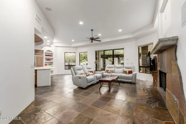 a large room with kitchen island a sink a stove and a refrigerator