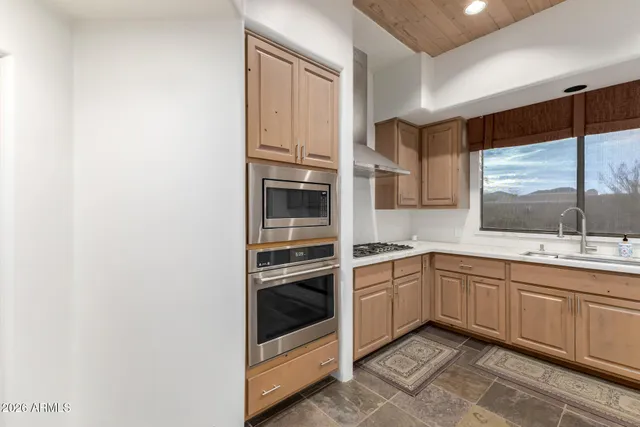 a bathroom with a granite countertop bathtub sink vanity mirror and toilet