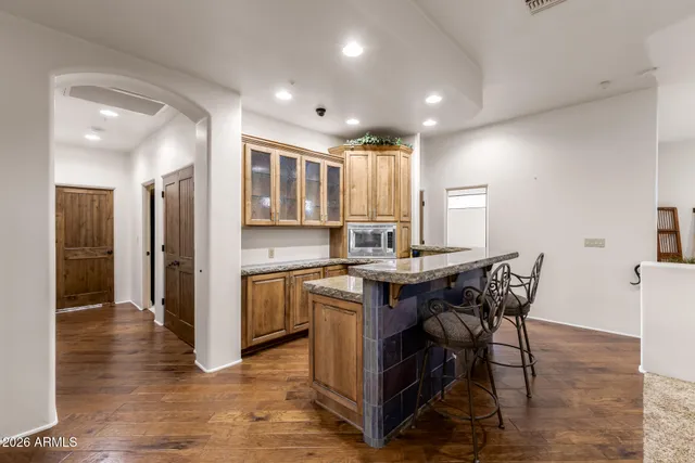 a patio with table and chairs with potted plants