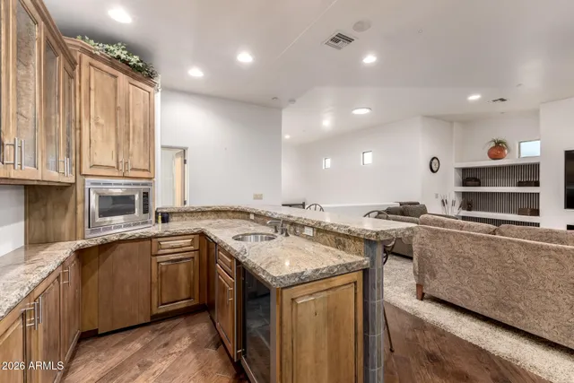 a view of a patio with a dining table and chairs under an umbrella